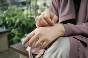 Close-up of hands with a beautiful ring in an outdoor setting, showcasing elegance.