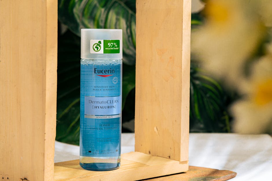 Eucerin DermatoCLEAN Hyaluron toner bottle surrounded by wooden frame and plants.